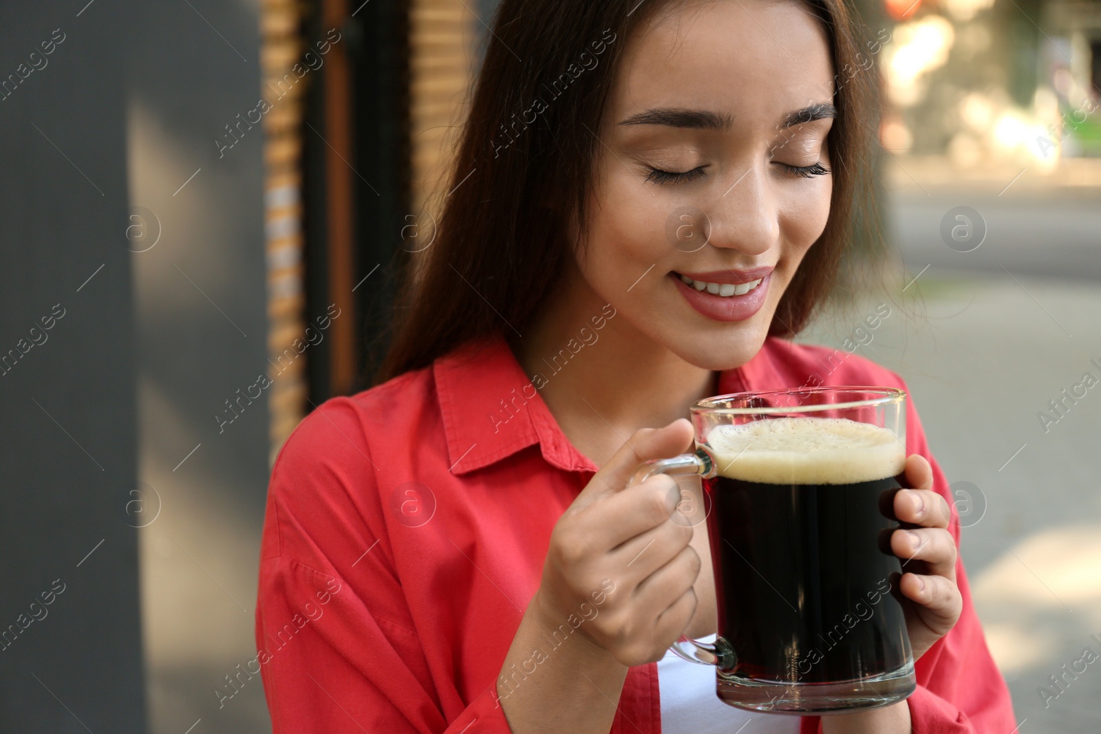 Photo of Beautiful woman with cold kvass outdoors. Traditional Russian summer drink