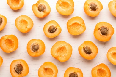 Photo of Flat lay composition with delicious ripe apricots on white wooden background