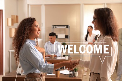 Image of Welcome to team. Employee shaking hands with intern in office