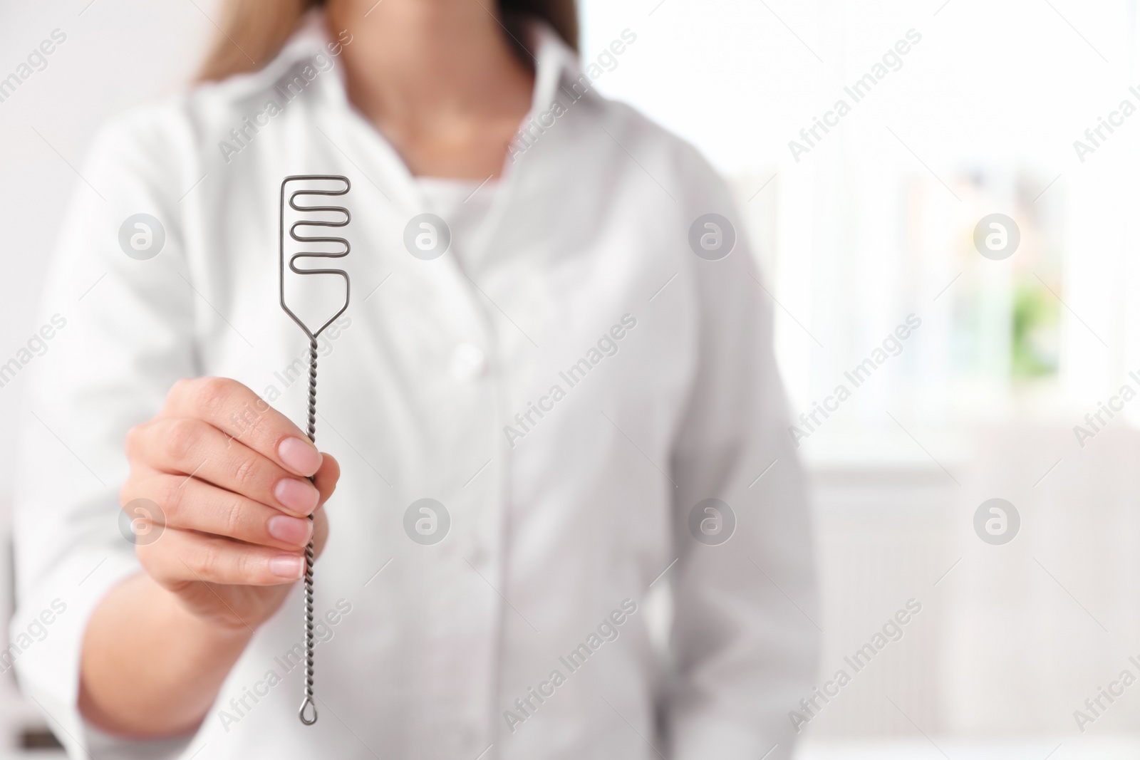 Photo of Speech therapist with logopedic probe in clinic, closeup. Space for text