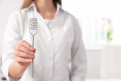 Speech therapist with logopedic probe in clinic, closeup. Space for text