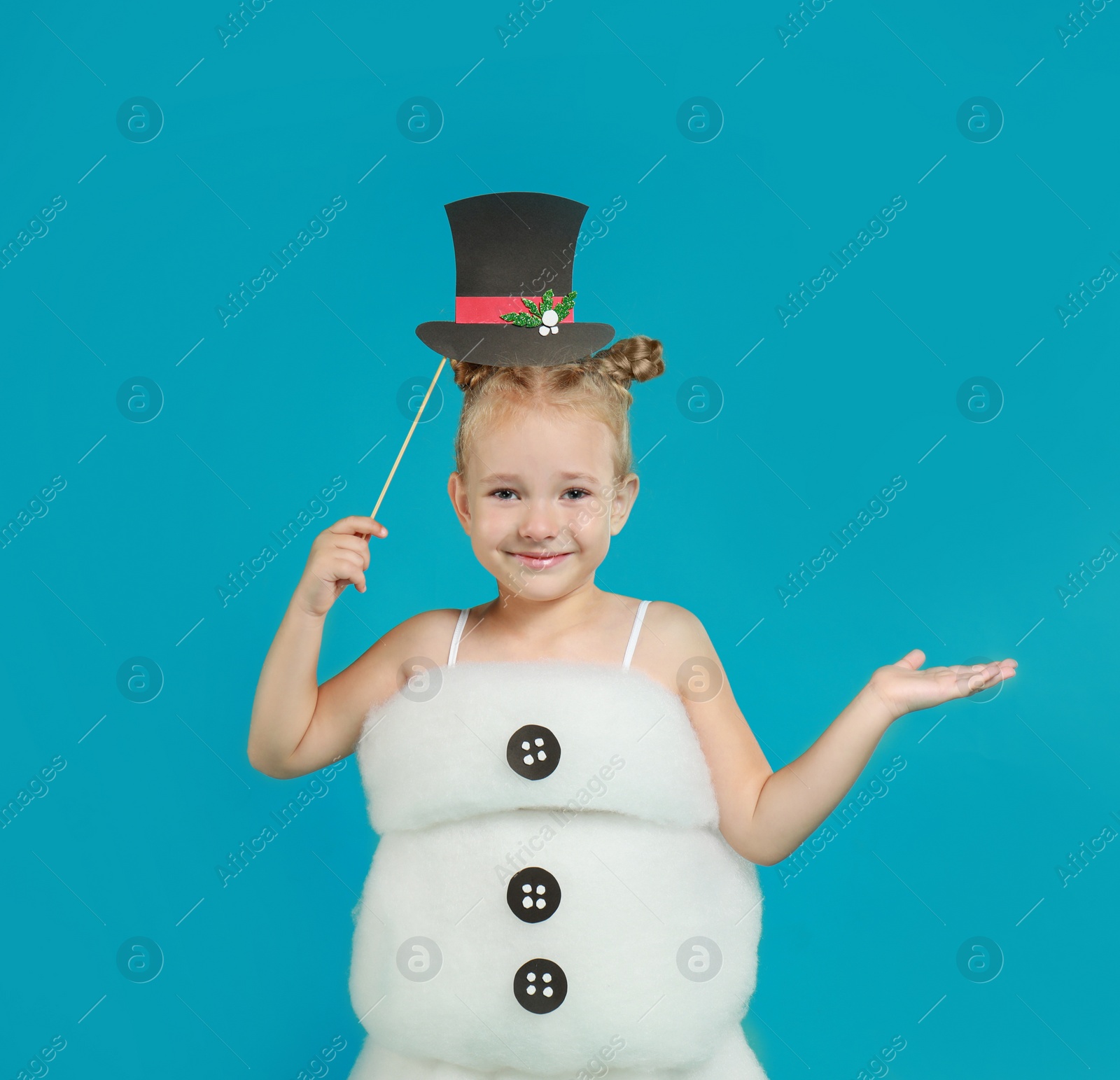 Image of Cute little girl dressed as snowman on light blue background. Christmas suit
