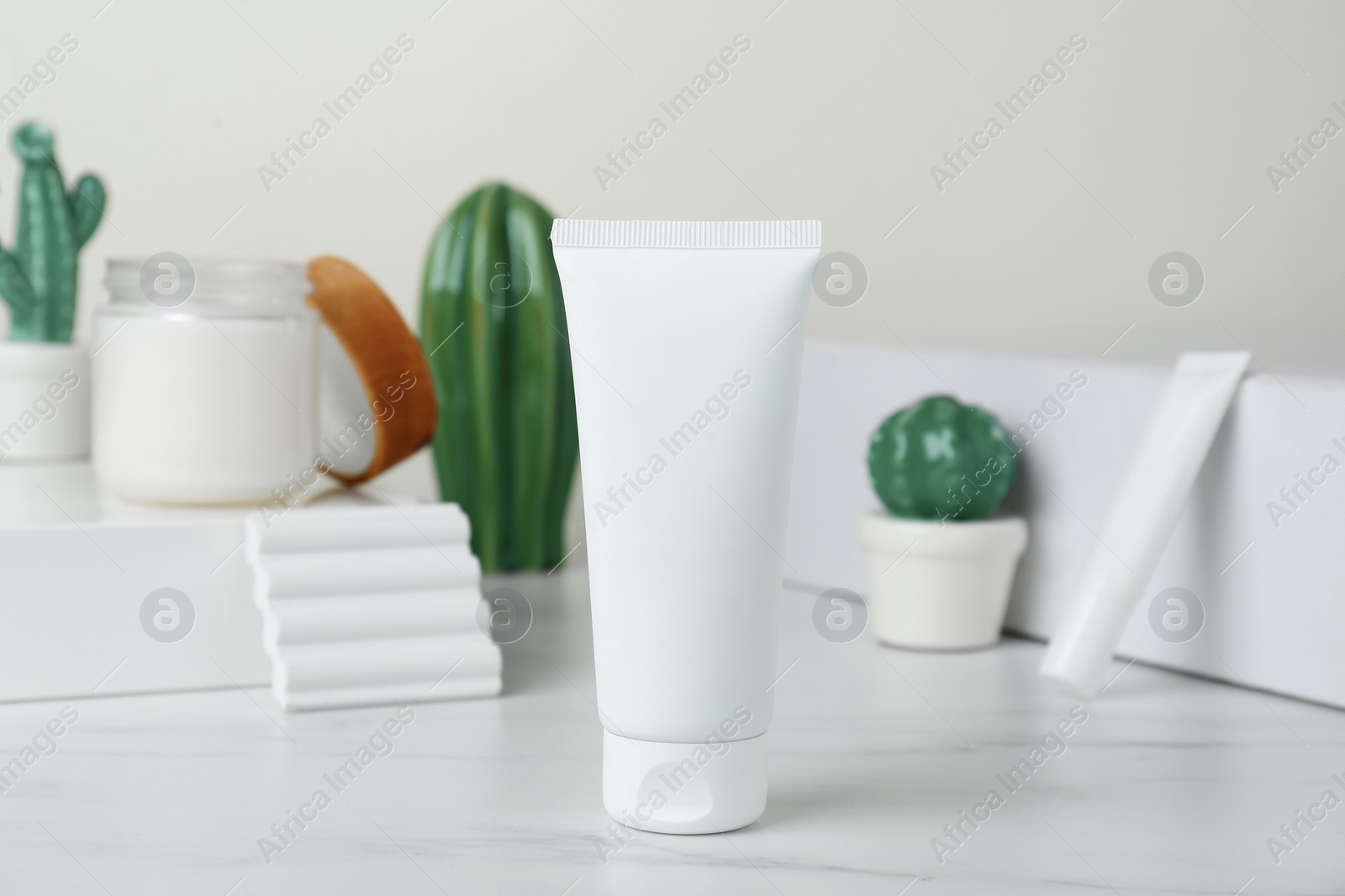 Photo of Tube of hand cream on white marble table