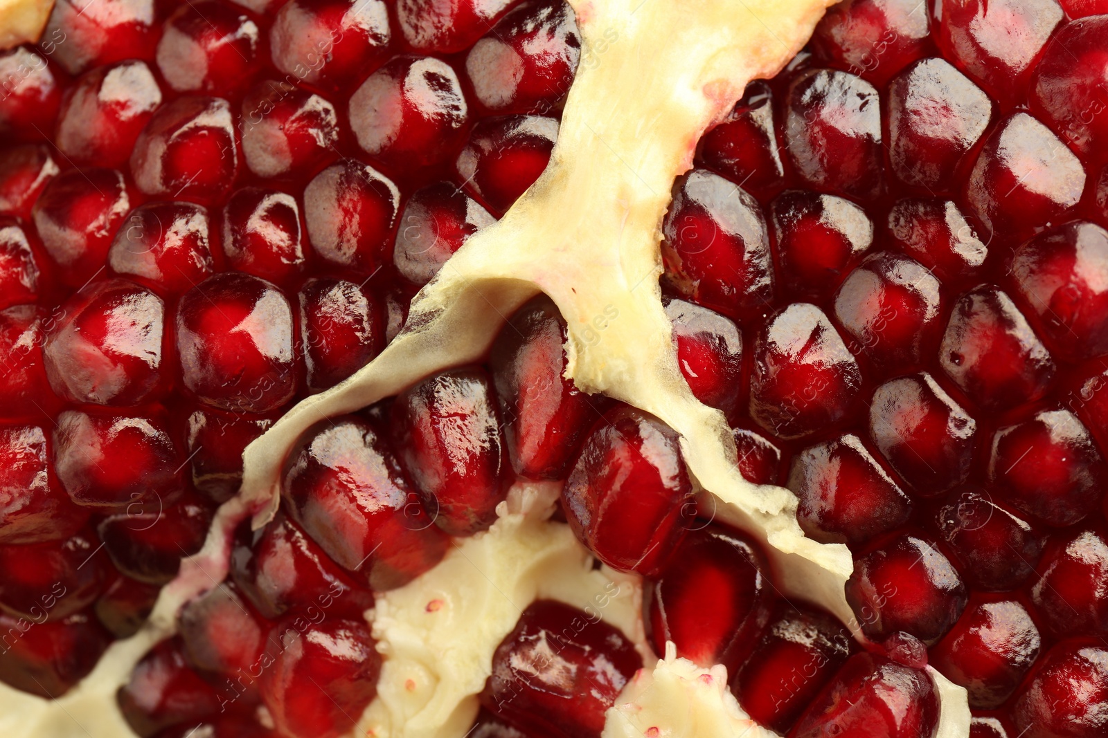 Photo of Ripe juicy pomegranate grains as background, closeup