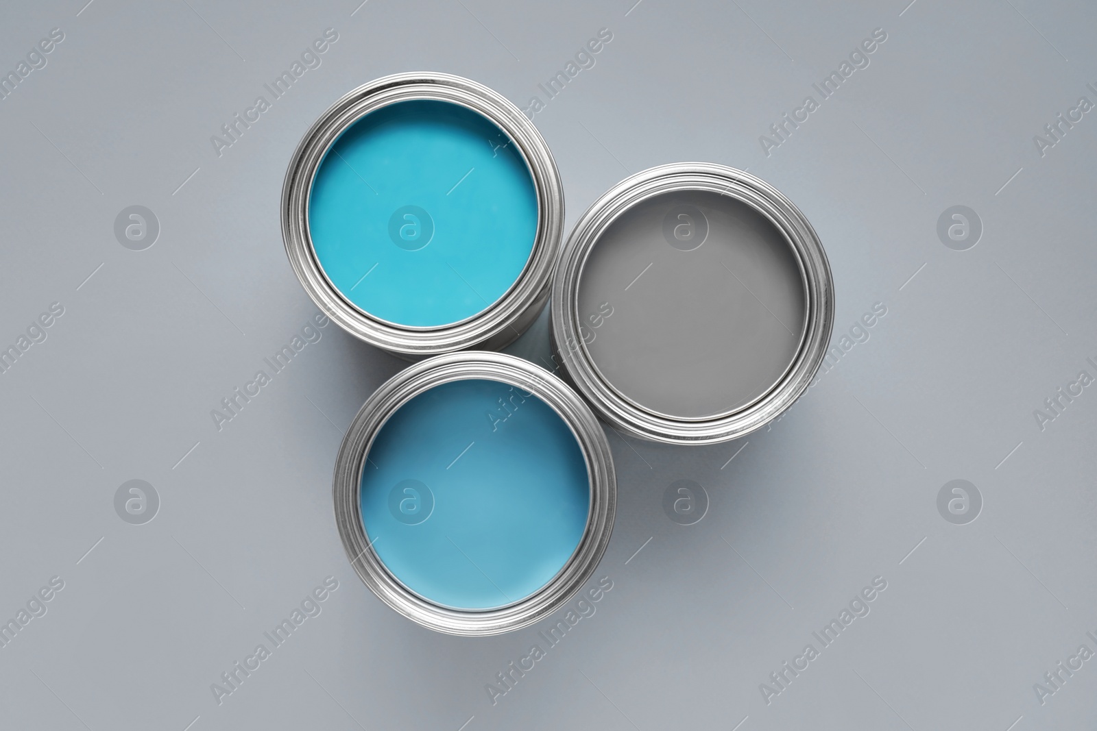 Photo of Cans with different paints on light background, flat lay