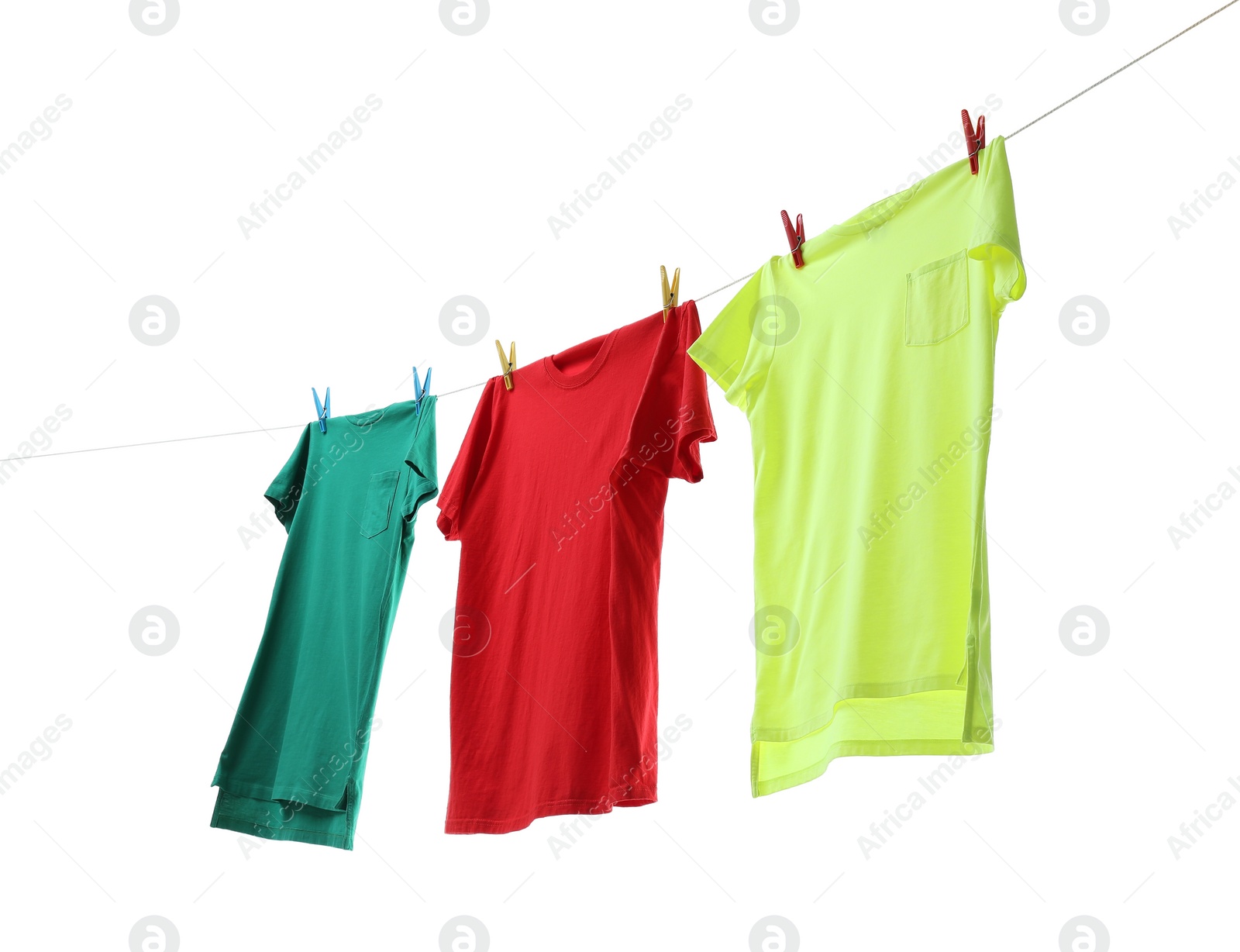 Photo of Colorful t-shirts drying on washing line isolated on white