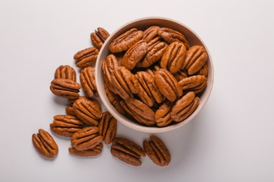 Photo of Tasty fresh ripe pecan nuts on white background, flat lay