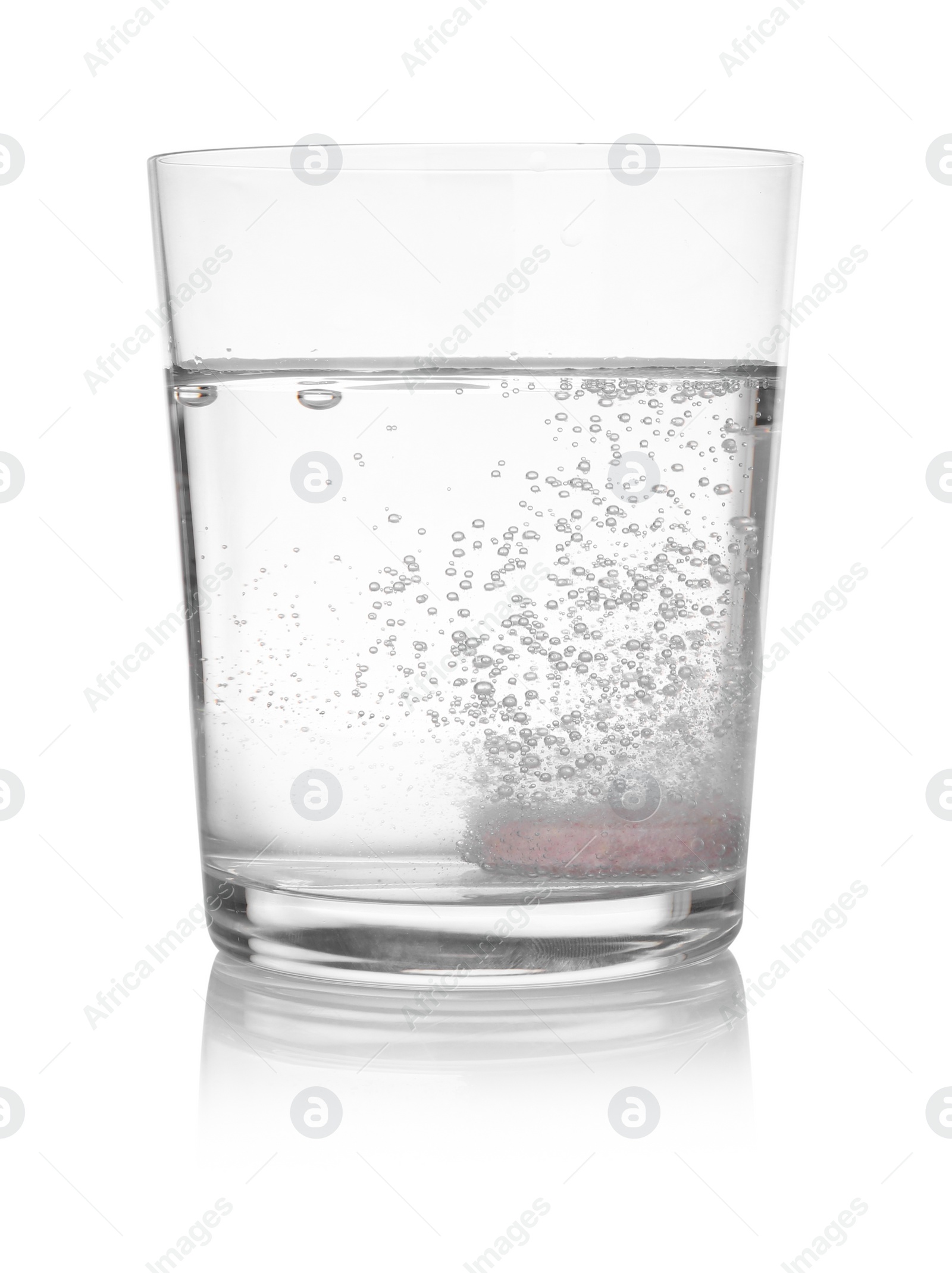 Photo of Effervescent pill dissolving in glass of water isolated on white