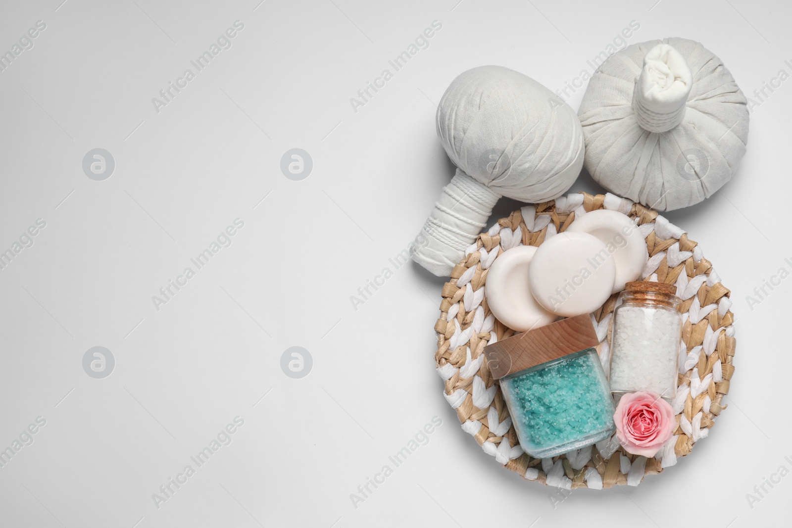 Photo of Flat lay composition of herbal bags and spa products on white background. Space for text