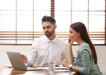 Insurance agent consulting young woman in office