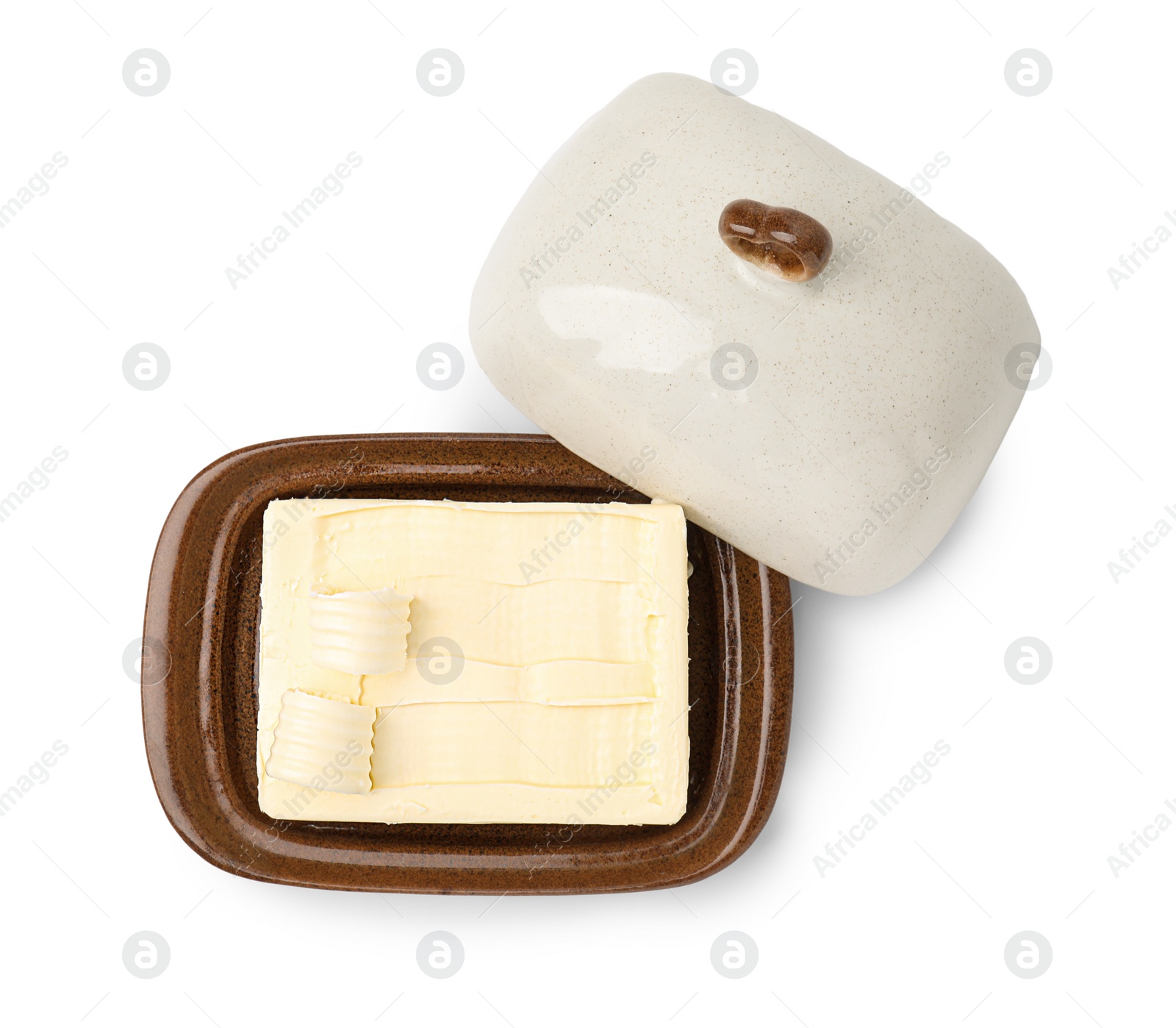 Photo of Tasty butter and curls in dish isolated on white, top view