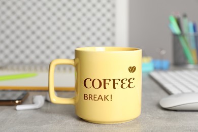 Mug with inscription Coffee Break on grey table