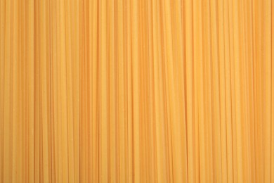 Photo of Raw spaghetti pasta as background, top view