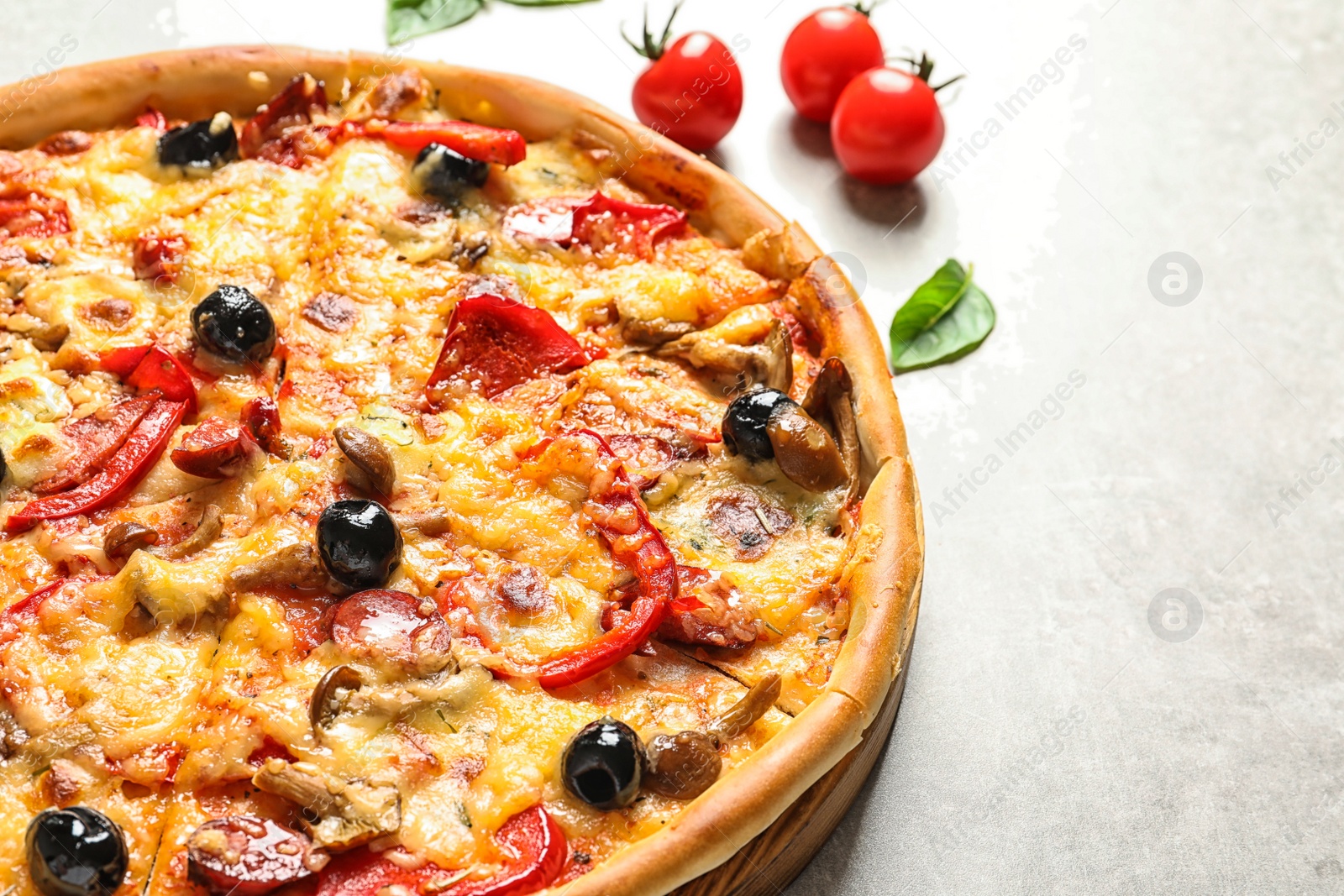 Photo of Delicious pizza with olives and sausages on table