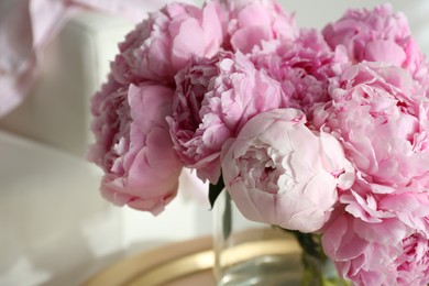 Bouquet of beautiful peonies on table indoors, closeup