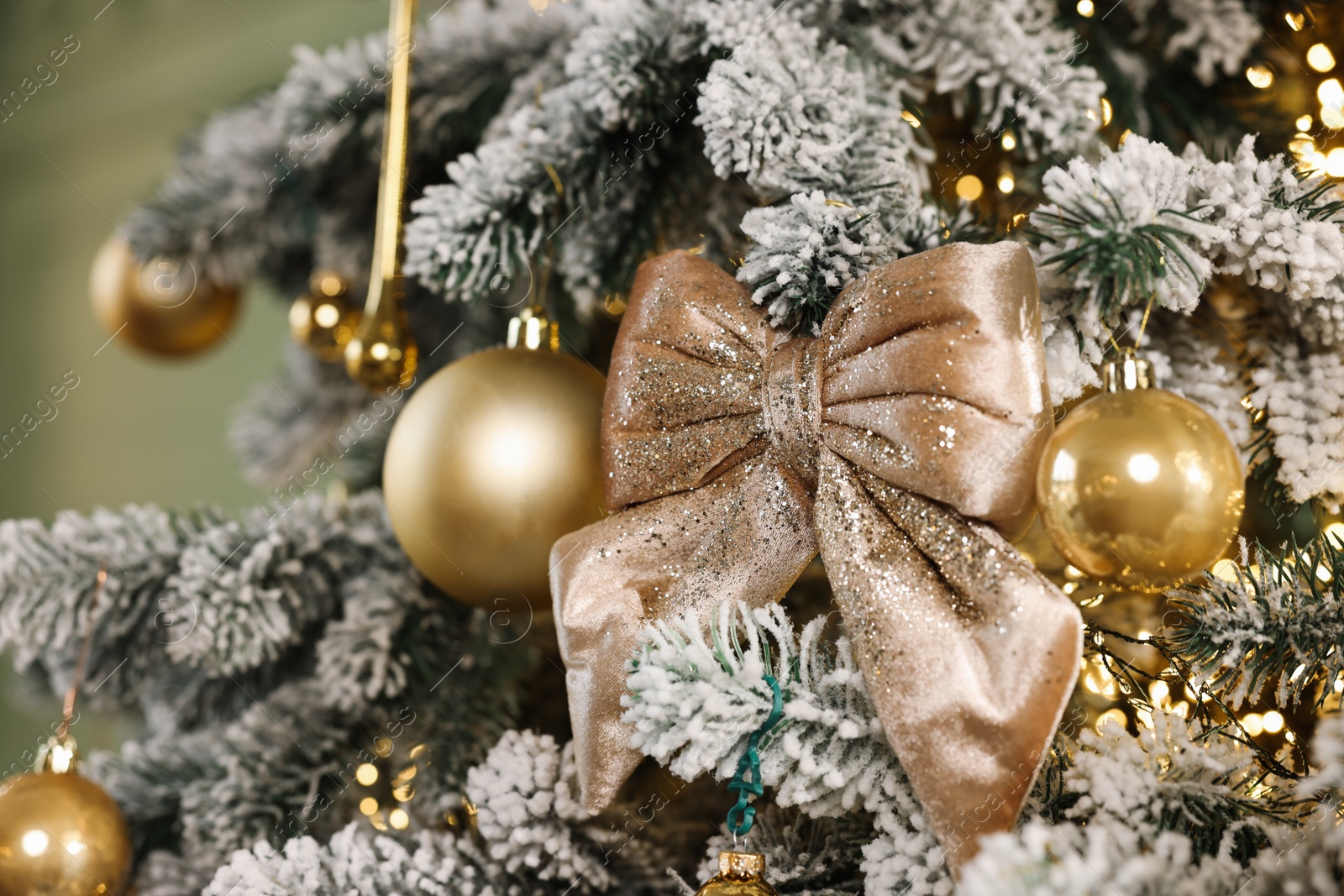 Photo of Beautiful decorated Christmas tree with baubles and lights on blurred background, closeup