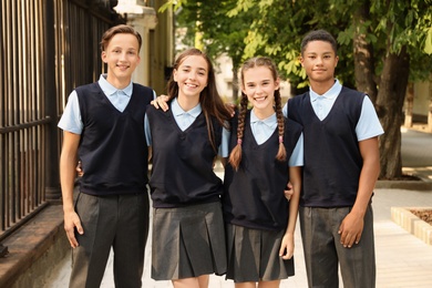 Teenage students in stylish school uniform outdoors