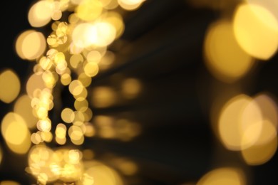 Photo of Golden blurred lights on black background. Bokeh effect