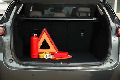 Set of car safety equipment in trunk, space for text