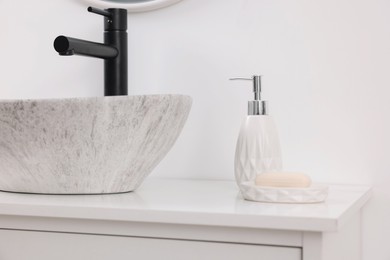 Different bath accessories and personal care products on bathroom vanity indoors