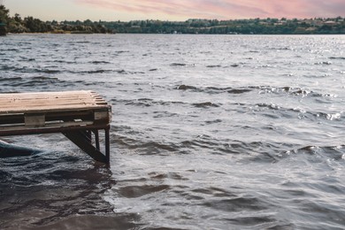 Photo of Beautiful river scene with wooden pier on sunny day