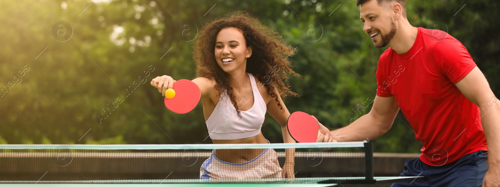 Image of Friends playing ping pong outdoors on summer day, space for text. Banner design