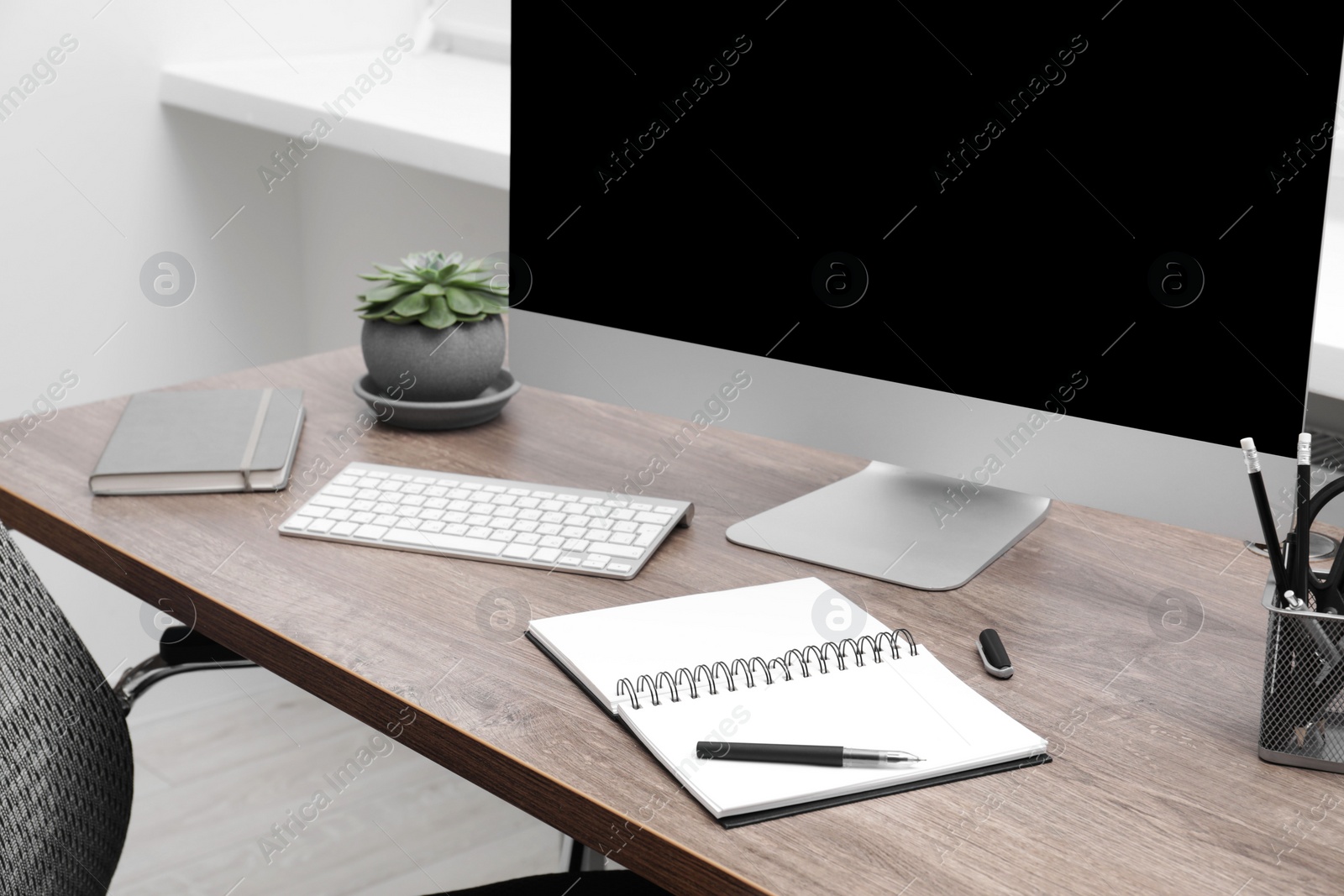 Photo of Cosy workspace with computer on desk at home