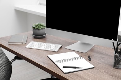 Photo of Cosy workspace with computer on desk at home