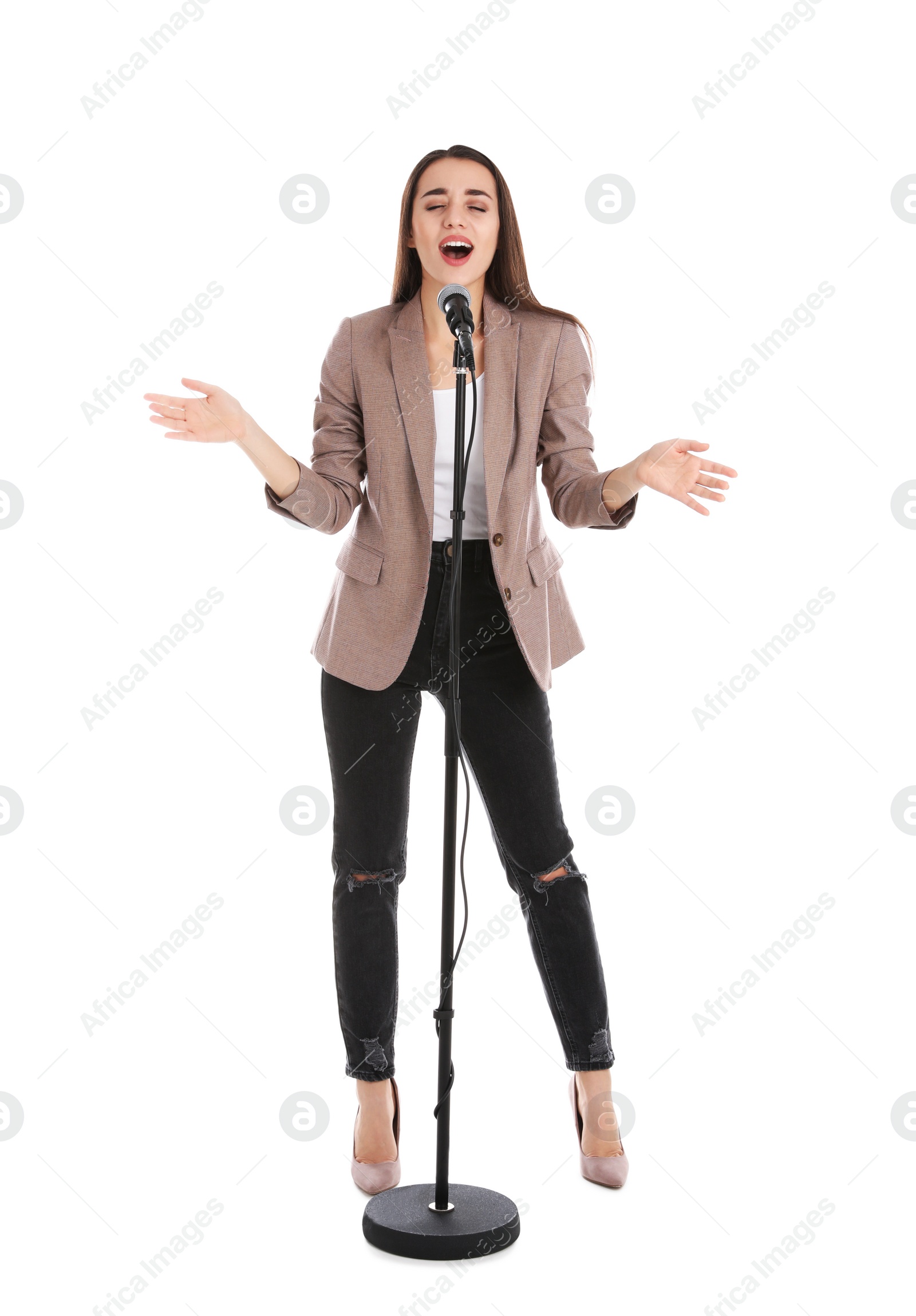 Photo of Young stylish woman singing in microphone on white background