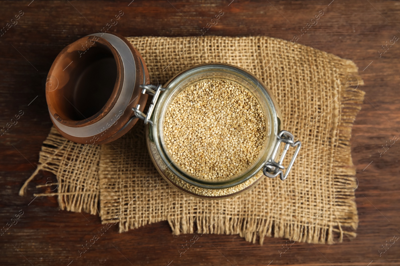 Photo of Jar with white quinoa on wooden table, top view