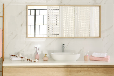 Large mirror over vessel sink in stylish bathroom interior