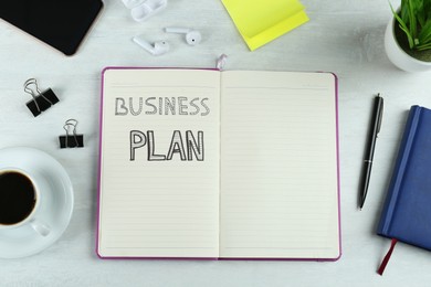 Business plan. Flat lay composition with notebook and coffee on white table