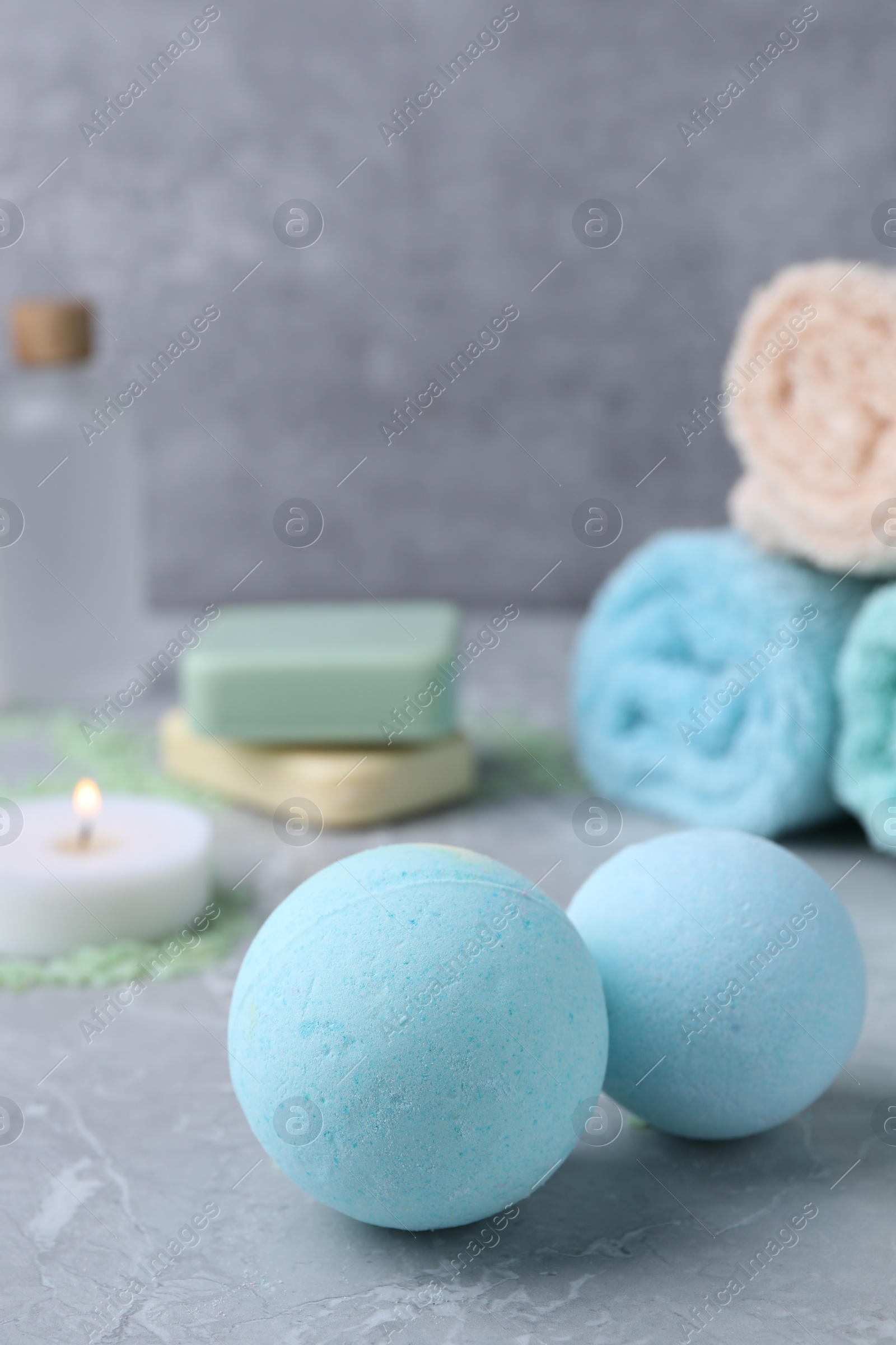 Photo of Beautiful aromatic bath bombs on light grey table, closeup. Space for text