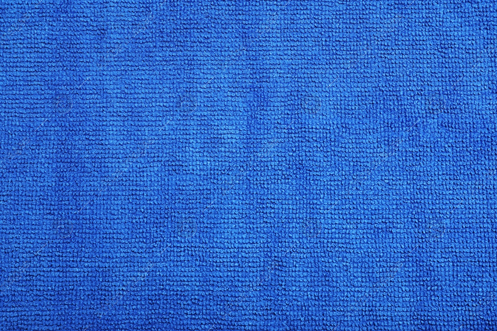 Photo of Blue microfiber cloth as background, top view