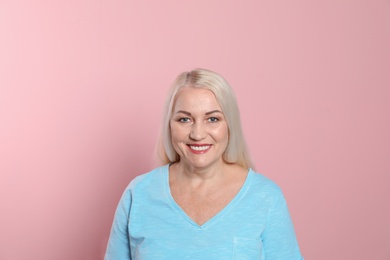 Smiling woman with perfect teeth on color background