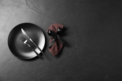 Photo of Stylish setting with elegant cutlery on grey textured table, flat lay. Space for text