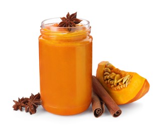 Jar of pumpkin jam, star anise, fresh pumpkin and cinnamon on white background