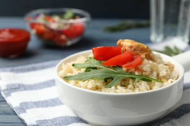 Photo of Delicious chicken risotto served in bowl on table
