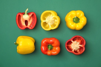 Flat lay composition with raw ripe paprika peppers on color background