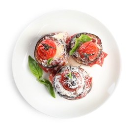 Baked eggplant with tomatoes, cheese and basil in plate isolated on white, top view