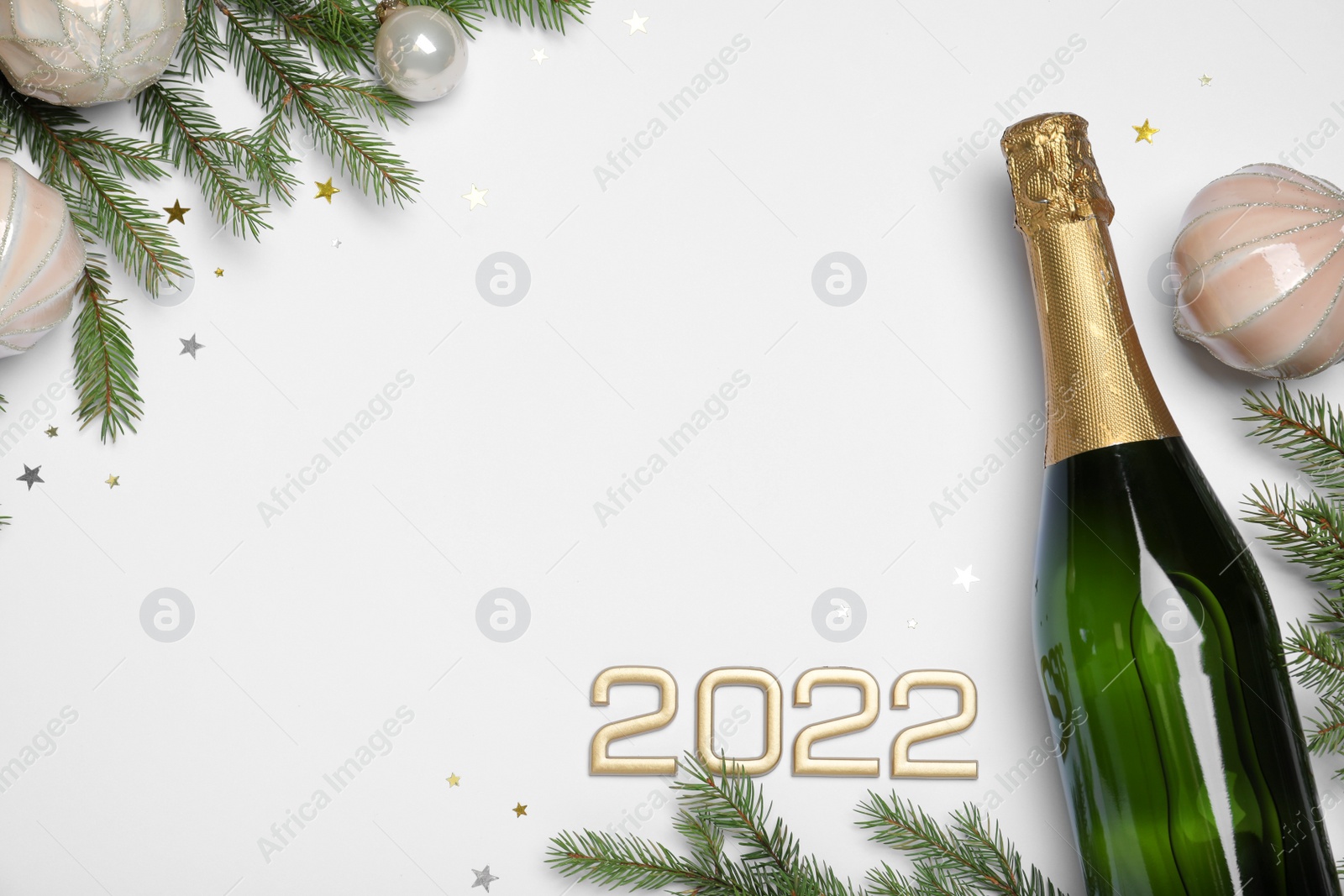 Photo of Happy New Year 2022! Flat lay composition with bottle of sparkling wine on light background, space for text