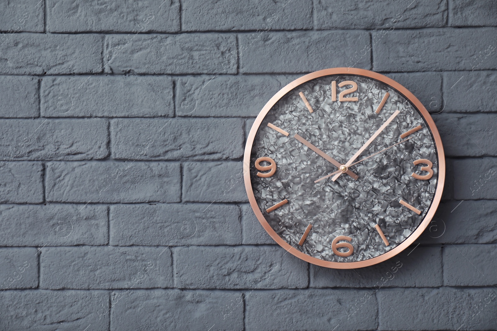 Photo of Modern clock on brick wall. Time concept