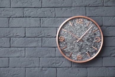 Modern clock on brick wall. Time concept