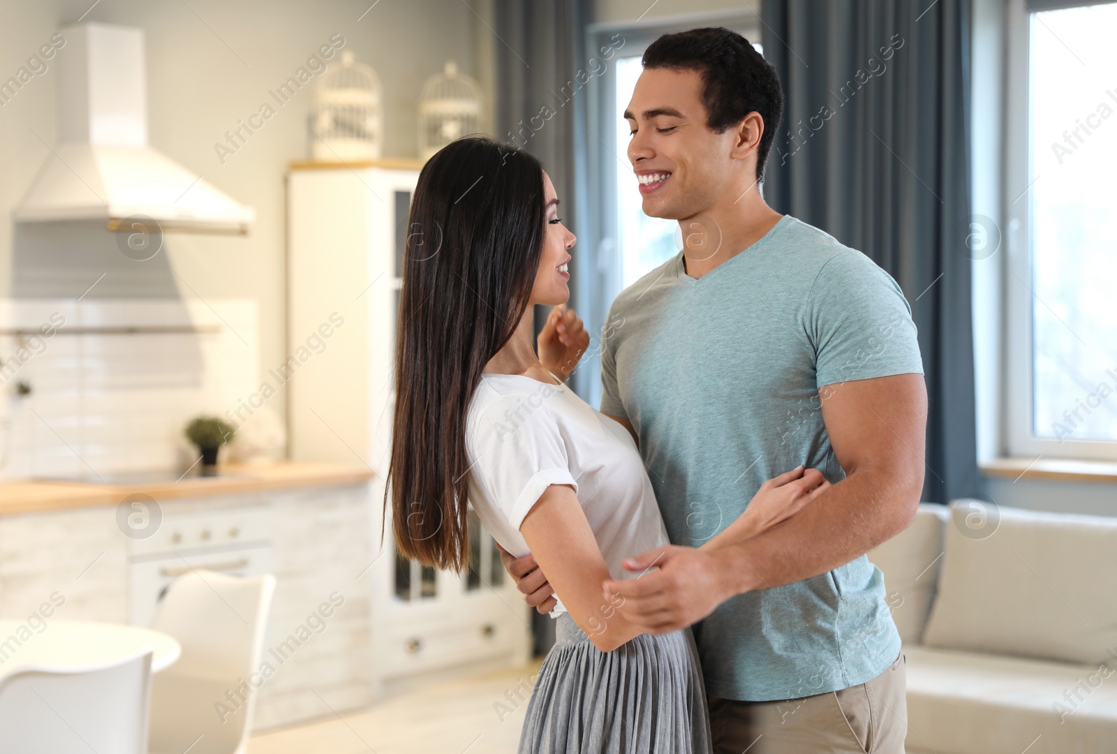 Photo of Lovely young interracial couple dancing at home