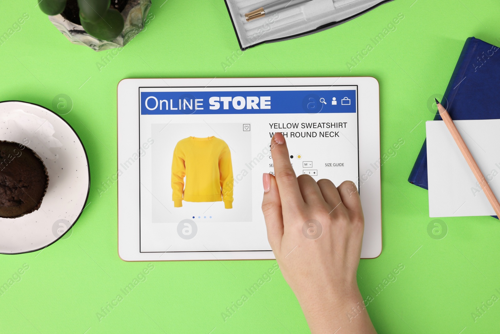 Photo of Woman with tablet shopping online on green background, top view