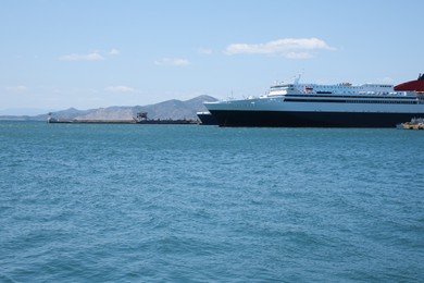 Modern ferry in sea port on sunny day