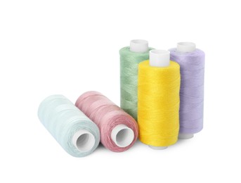 Photo of Many different colorful sewing threads on white background