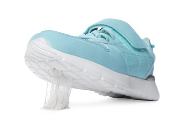 Shoe with chewing gum on sole against white background