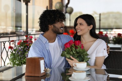 Photo of International dating. Happy couple spending time together in restaurant