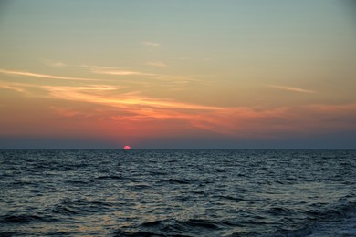 Photo of Beautiful sky with sun over sea at sunset